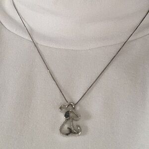 Adorable sterling silver necklace with dog/heart pendant.